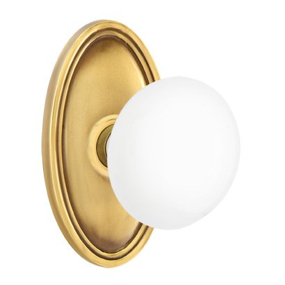 Emtek Passage Ice White Porcelain Knob With Oval Rosette in French Antique Brass