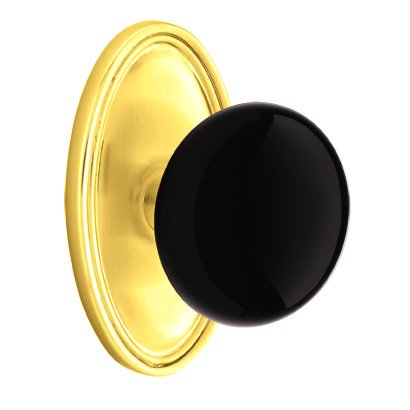 Emtek Privacy Ebony Knob And Oval Rosette With Concealed Screws in Unlacquered Brass