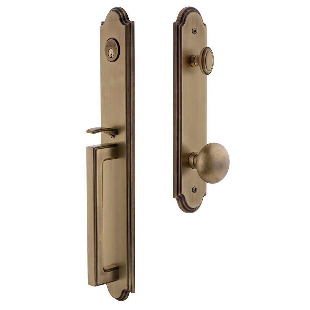 Grandeur Arc One-Piece Handleset with D Grip and Fifth Avenue Knob in Vintage Brass