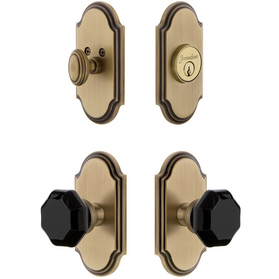 Grandeur Arc Plate with Lyon Knob and matching Deadbolt in Vintage Brass