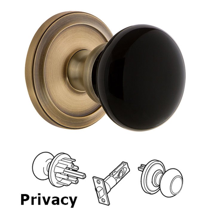 Grandeur Privacy - Circulaire Rosette with Black Coventry Porcelain Knob in Vintage Brass