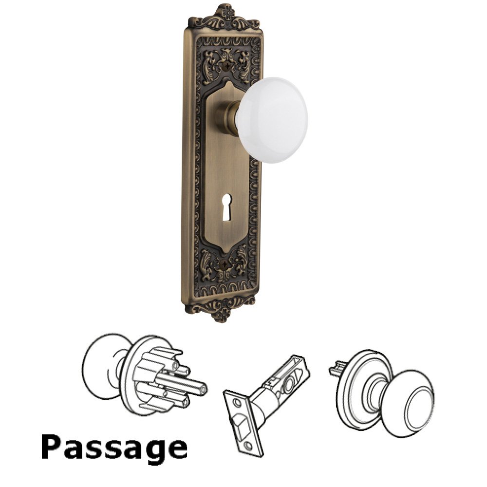 Nostalgic Warehouse Complete Passage Set With Keyhole - Egg & Dart Plate with White Porcelain Knob in Antique Brass