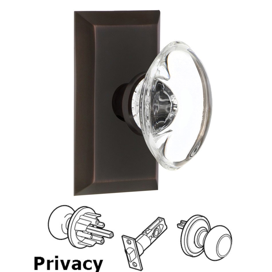 Nostalgic Warehouse Complete Privacy Set - Studio Plate with Oval Clear Crystal Glass Door Knob in Timeless Bronze