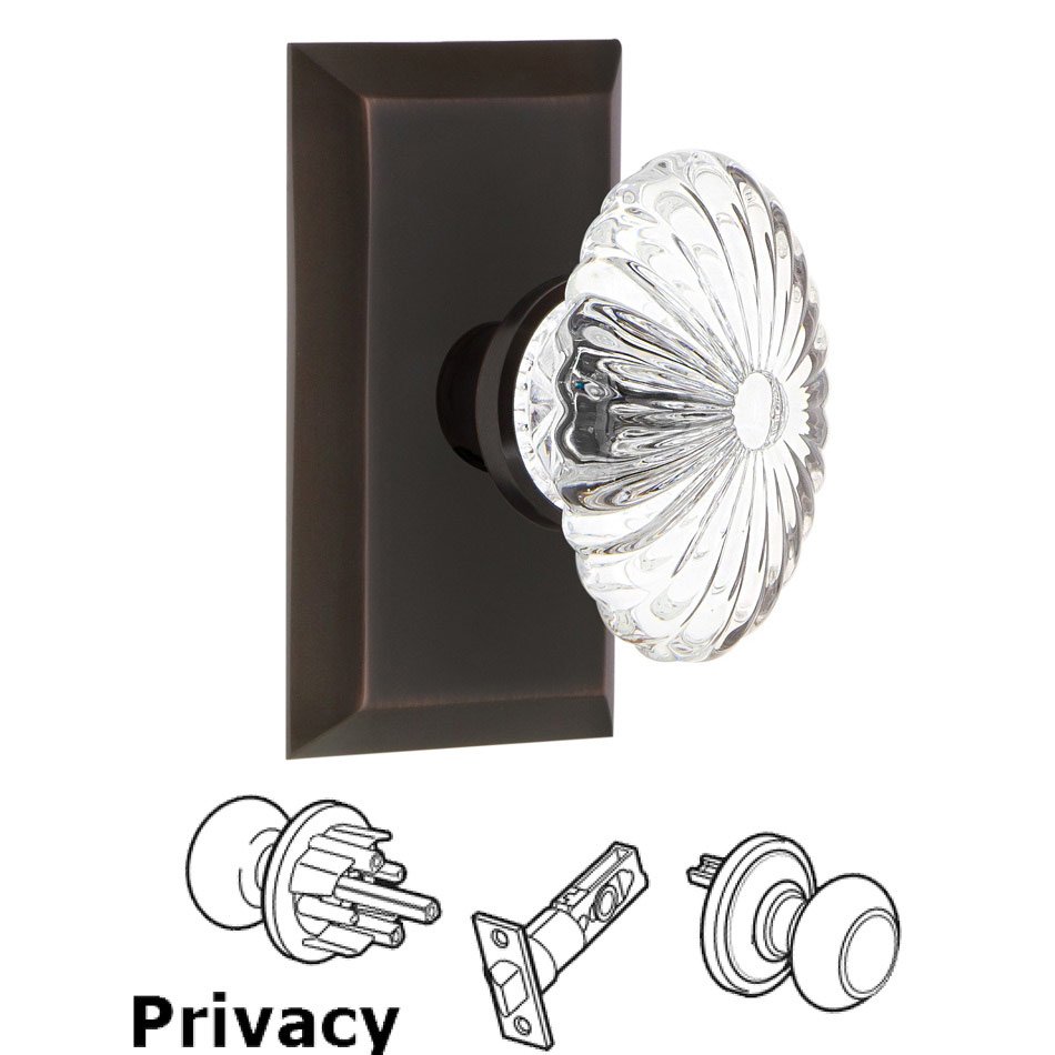Nostalgic Warehouse Complete Privacy Set - Studio Plate with Oval Fluted Crystal Glass Door Knob in Timeless Bronze