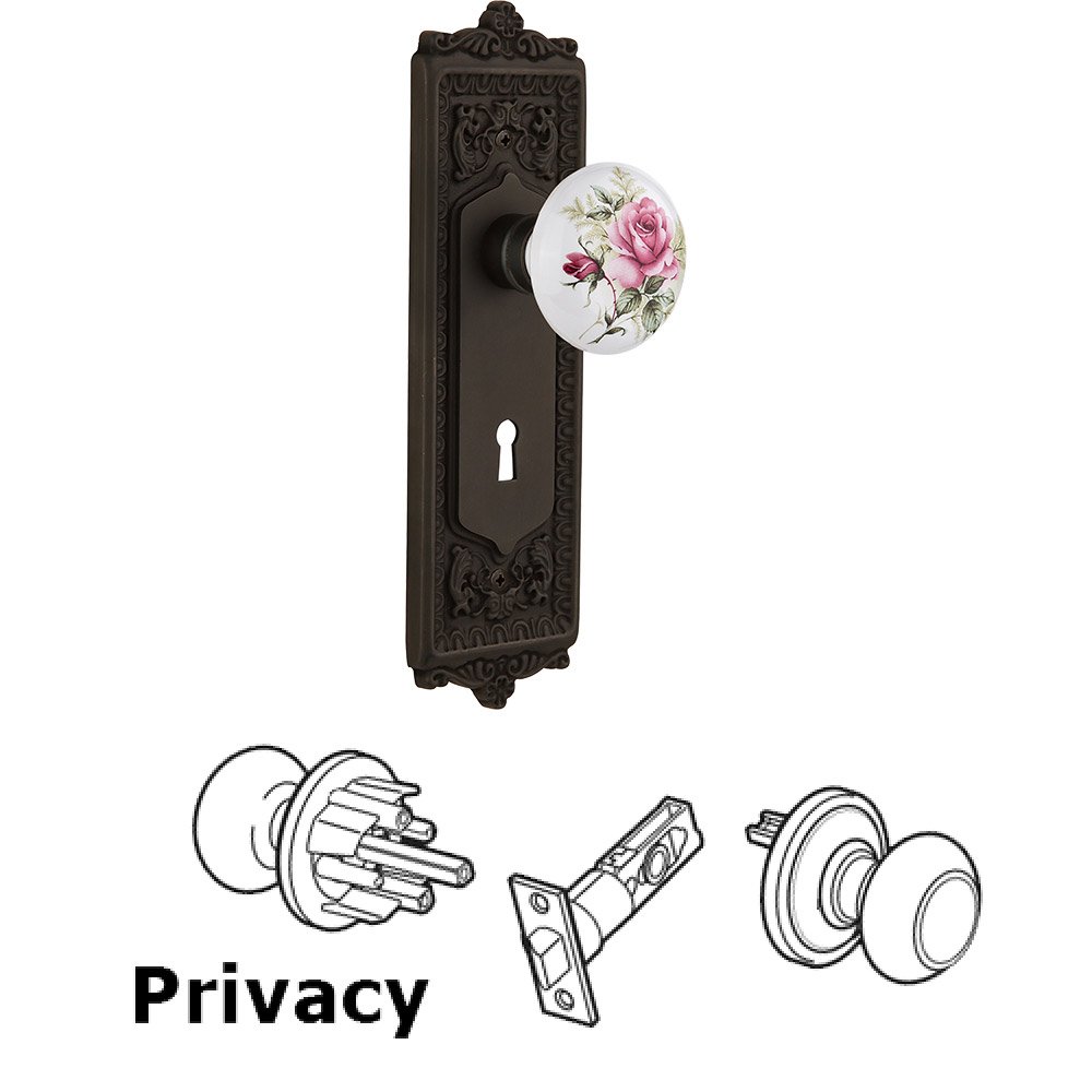 Nostalgic Warehouse Privacy Knob - Egg and Dart Plate with Rose Porcelain Knob with Keyhole in Oil Rubbed Bronze