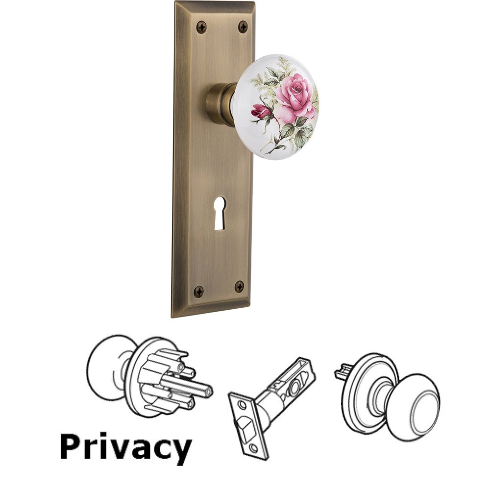 Nostalgic Warehouse Privacy New York Plate with Keyhole and White Rose Porcelain Door Knob in Antique Brass