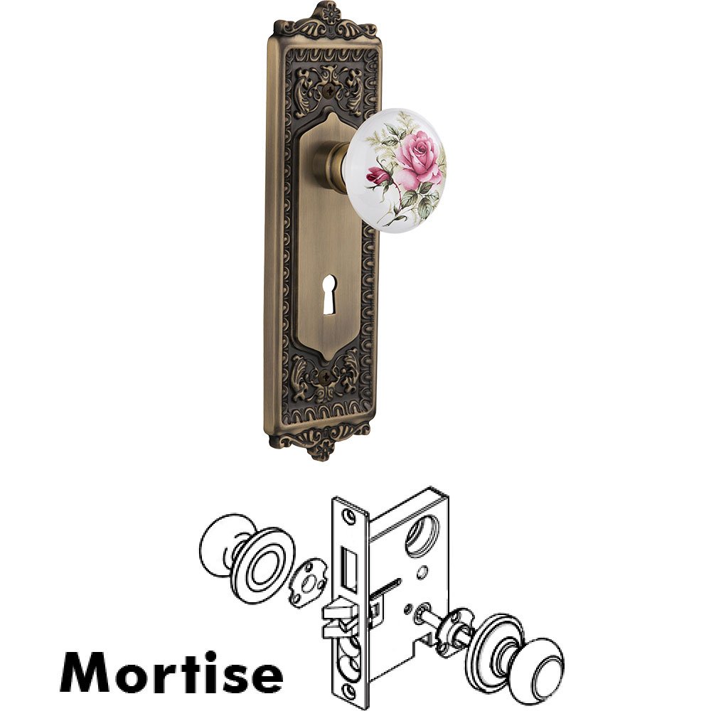 Nostalgic Warehouse Mortise - Egg and Dart Plate with Rose Porcelain Knob with Keyhole in Antique Brass