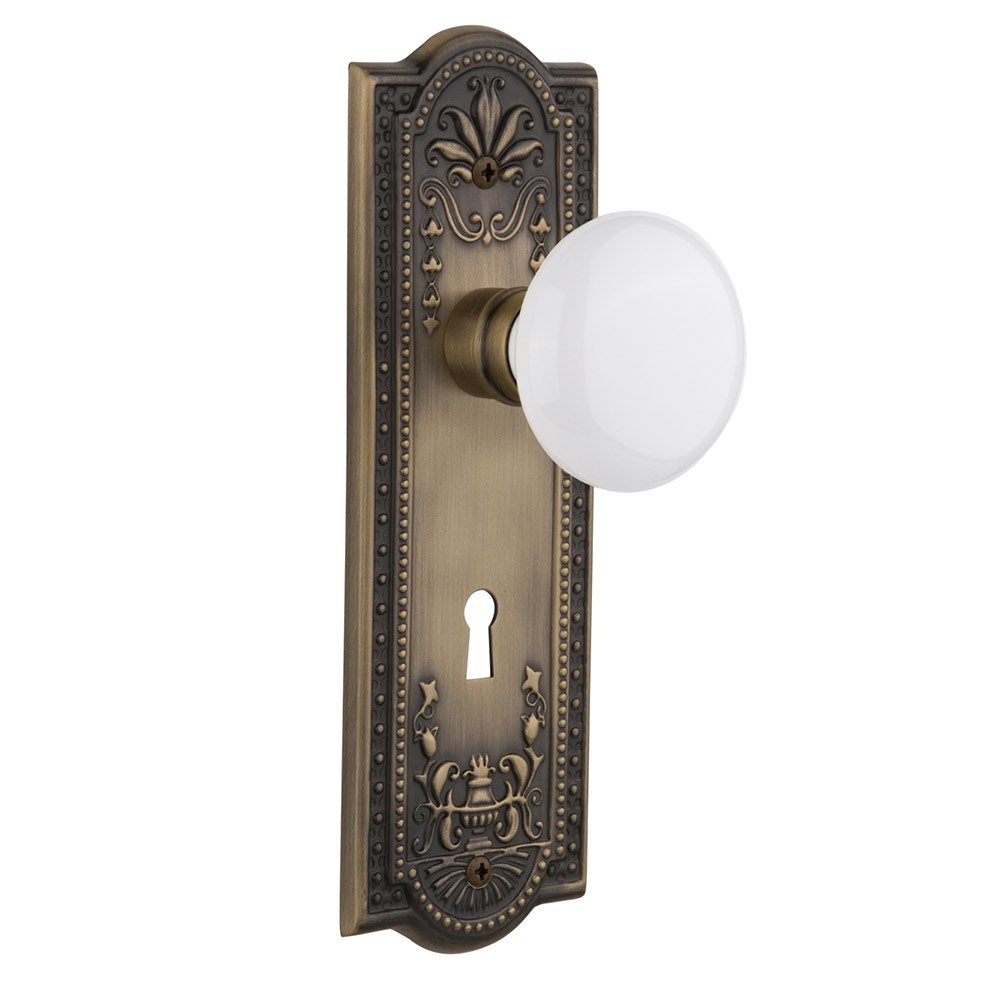 Nostalgic Warehouse Privacy Meadows Plate with Keyhole and White Porcelain Door Knob in Antique Brass