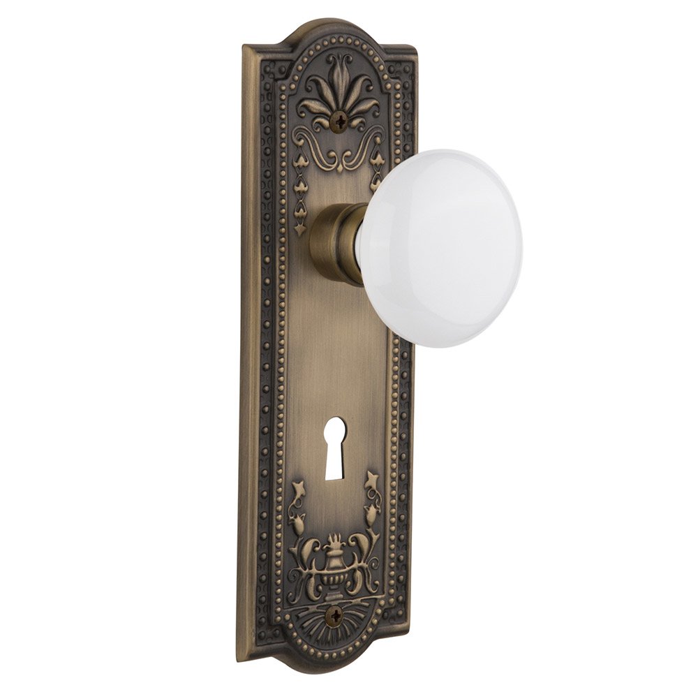 Nostalgic Warehouse Passage Meadows Plate with Keyhole and White Porcelain Door Knob in Antique Brass