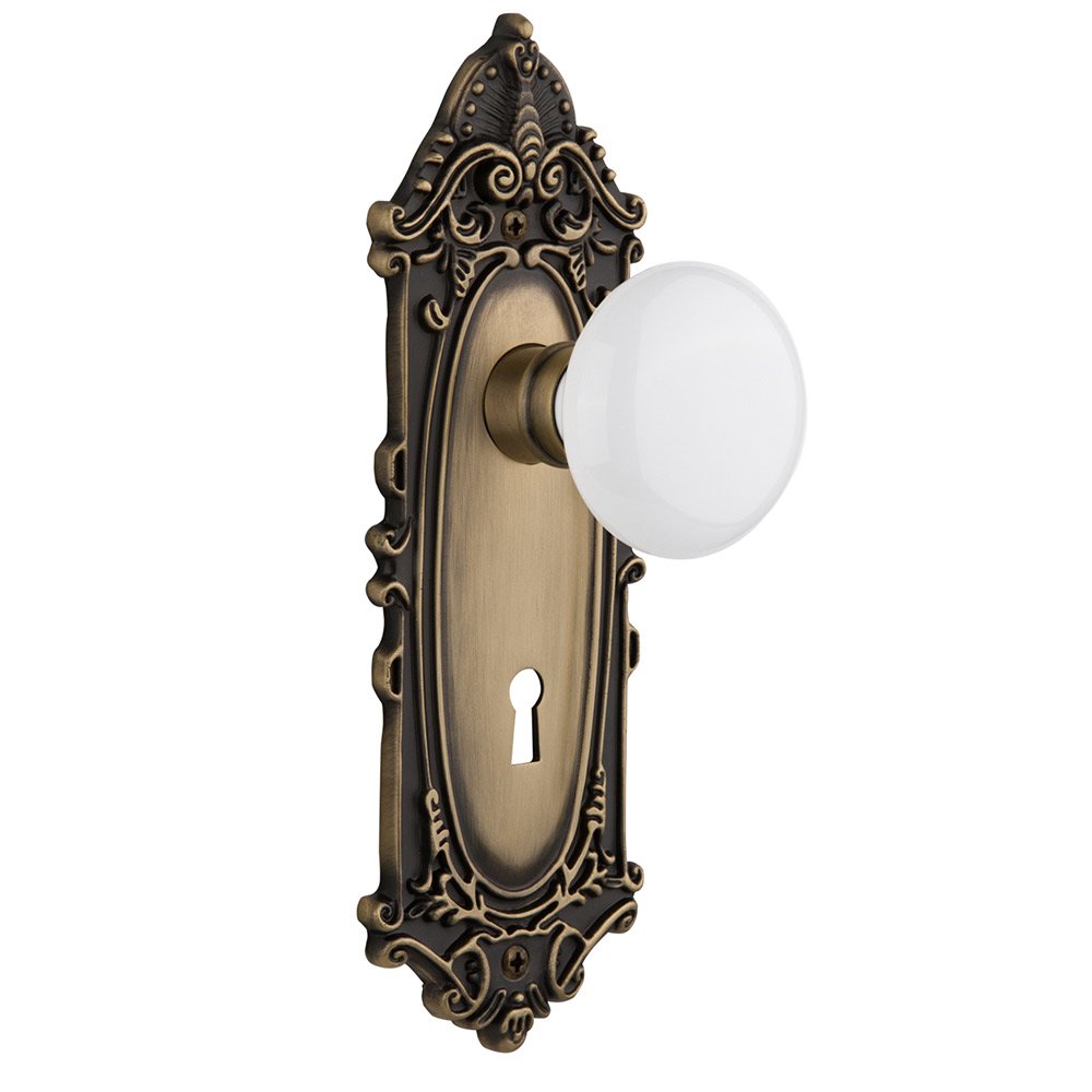 Nostalgic Warehouse Double Dummy Victorian Plate with Keyhole and White Porcelain Door Knob in Antique Brass