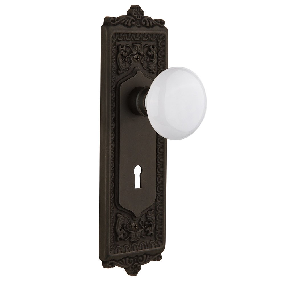 Nostalgic Warehouse Single Dummy Egg & Dart Plate with Keyhole and White Porcelain Door Knob in Oil-Rubbed Bronze